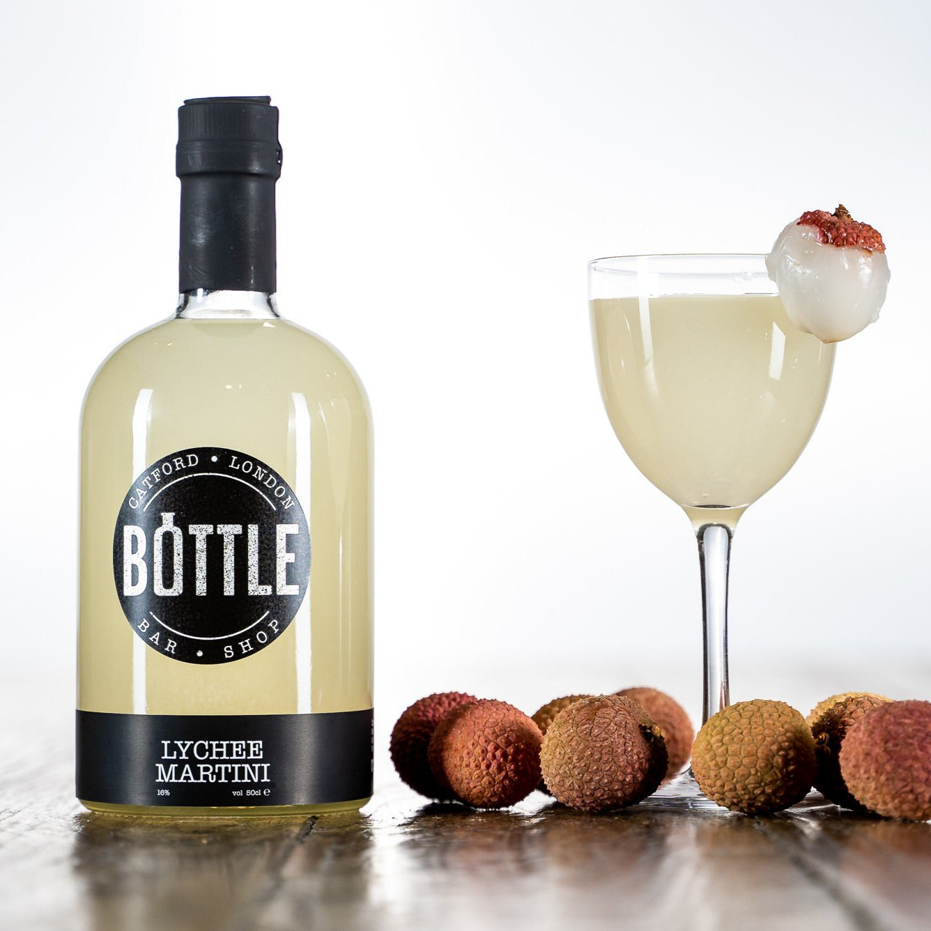 Delicious-lychee-martini-cocktail-with-lychees poured into a martini glass with a lychee garnish