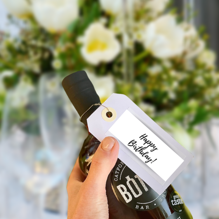 Happy birthday label on a handmade bottled cocktail
