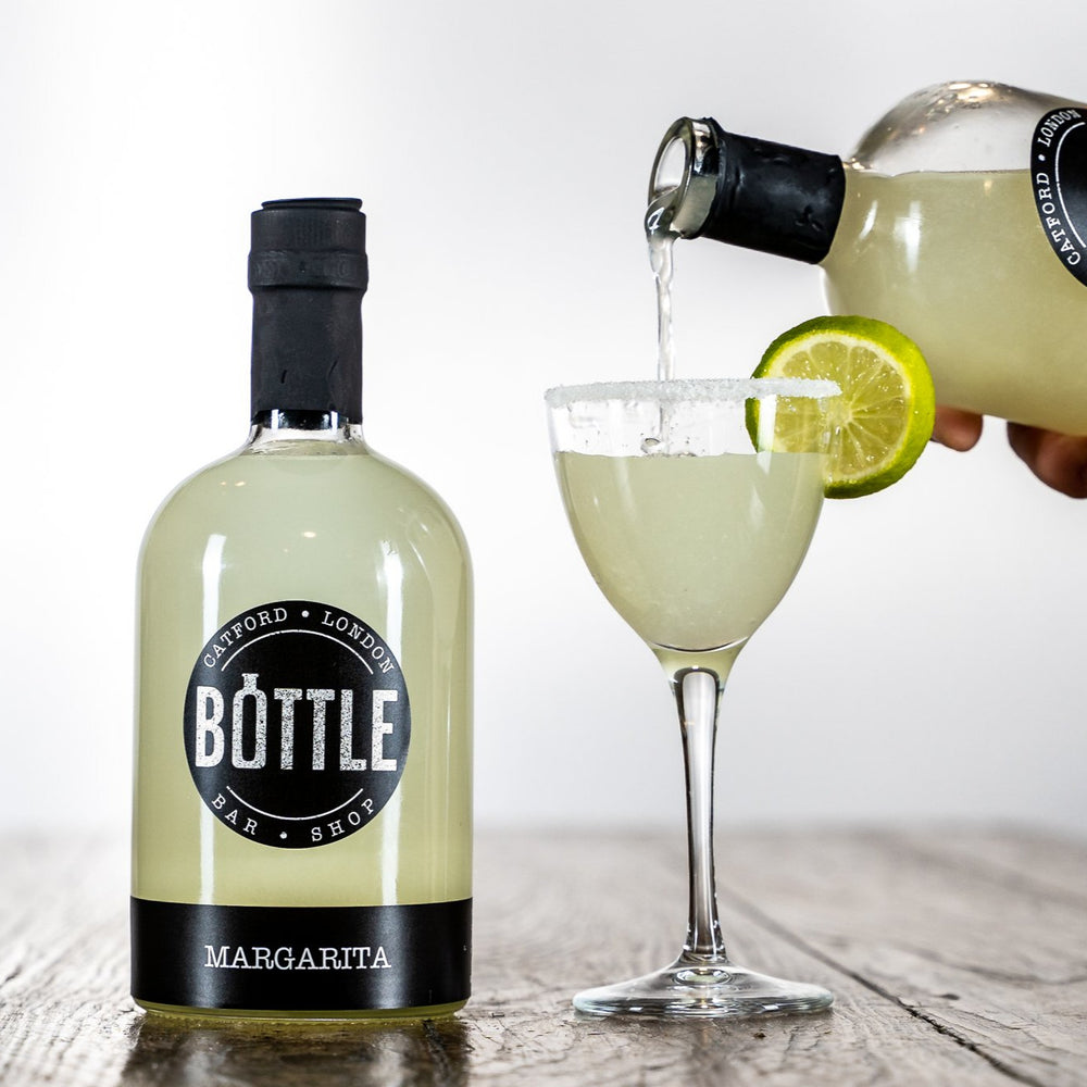 handmade-margarita-cocktail-with-salt-rim and lime garnish, made in the UK-, poured into a martini glass