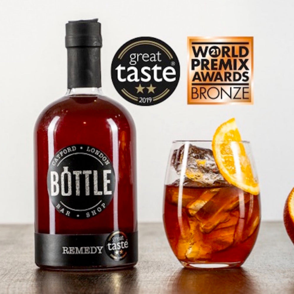 Handmade Award winning Remedy cocktail with awards, made in the UK, with a glass, with a garnish and ice